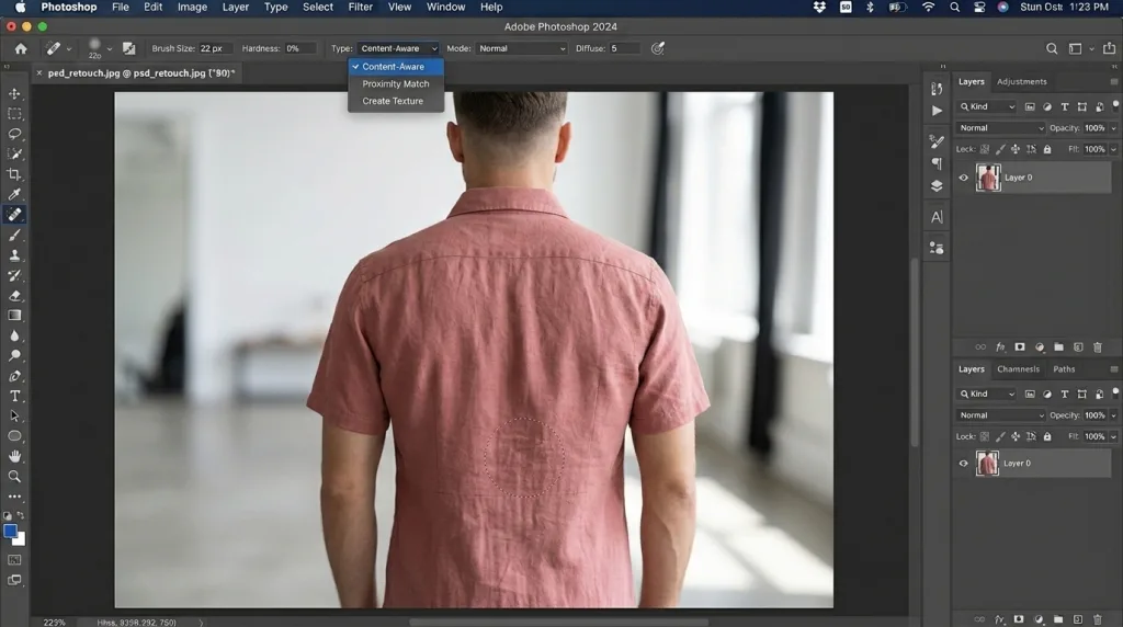 Using the Content-Aware Spot Healing Brush tool in Photoshop to remove small wrinkles from a solid-colored dress.