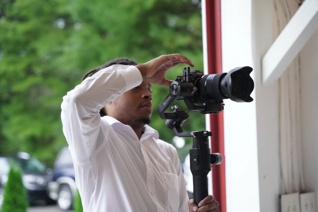 Videographer using a camcorder at a wedding ceremony