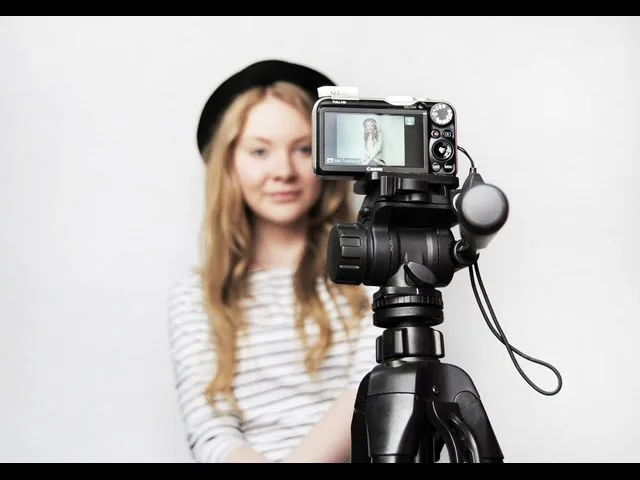 Photographer taking a portrait with a DSLR at a proper distance
