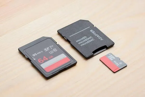 microSD card compared next to a full-size SD adapter showing size difference